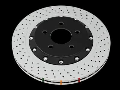 Disco freno DBA Serie 5000 XD caratterizzato da fori incrociati non direzionali e intagli su superficie argentata con mozzo centrale nero e indicatori colorati